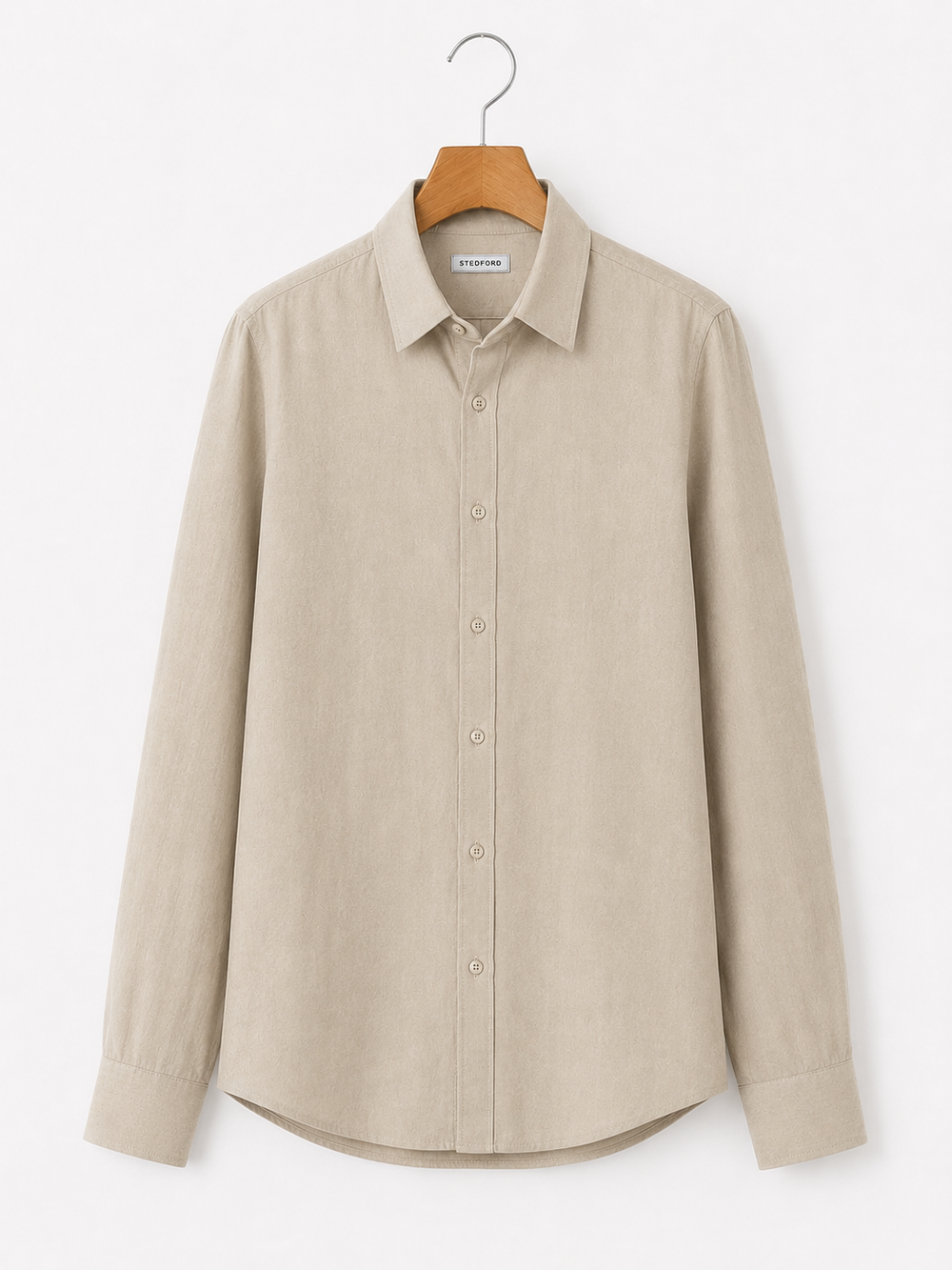 Beige shirt on a hanger against a white background