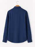 Blue shirt on a hanger against a white background