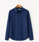Blue shirt on a hanger against a white background
