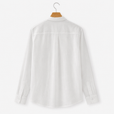 White shirt on a hanger against a white background