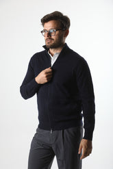 Stedford model wearing a dark blue jacket over a white shirt on a white background