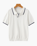 White polo shirt with black trim on a wooden hanger against a white background