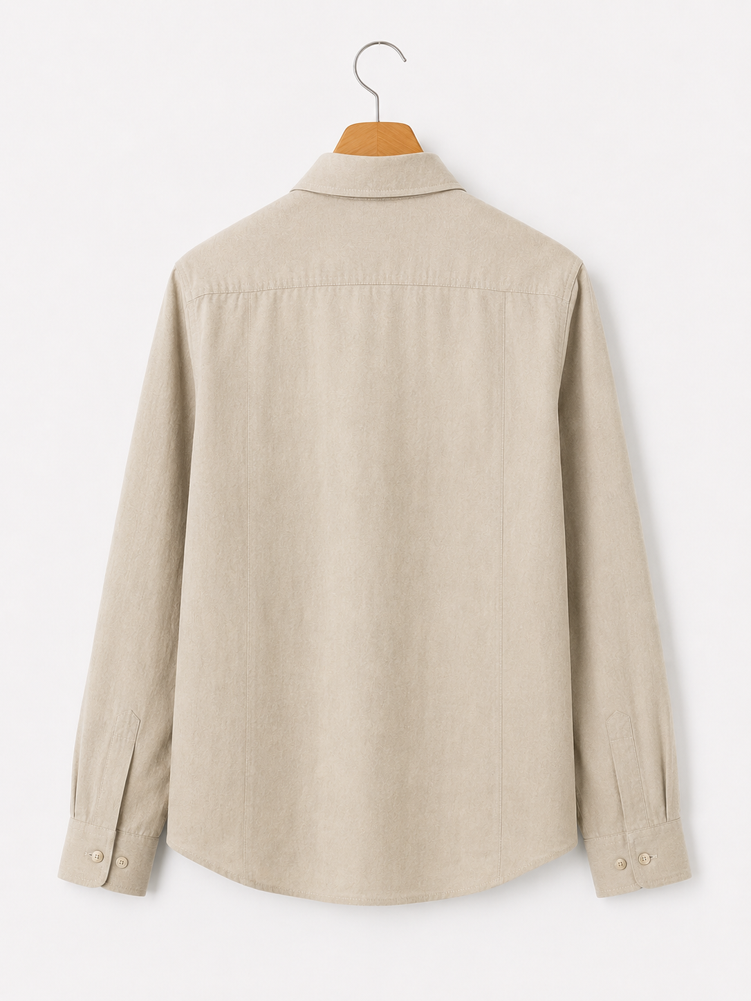 Beige shirt on a hanger against a white background