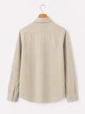 Beige shirt on a hanger against a white background