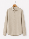 Beige shirt on a hanger against a white background