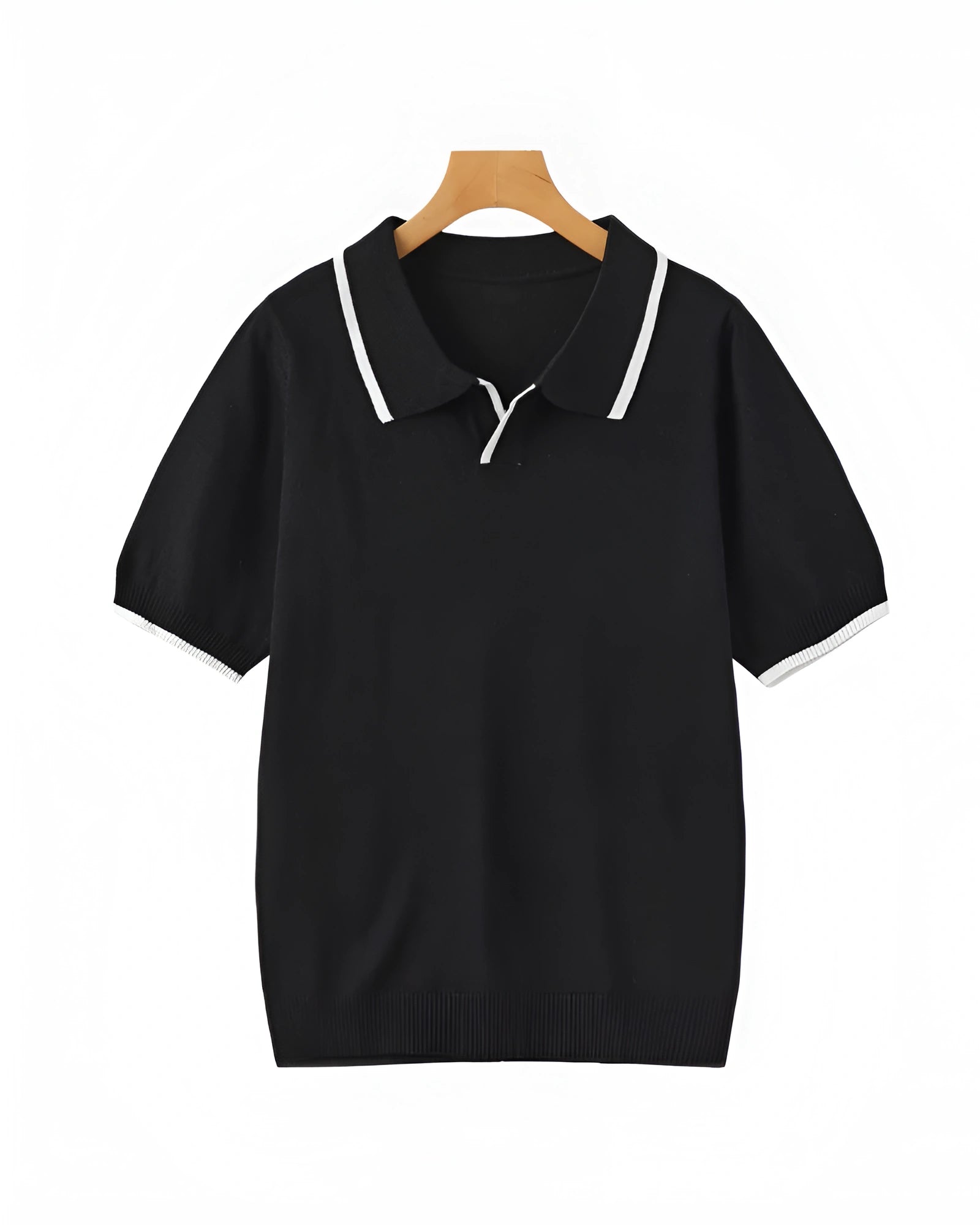 Black polo shirt with white trim on a wooden hanger against a white background
