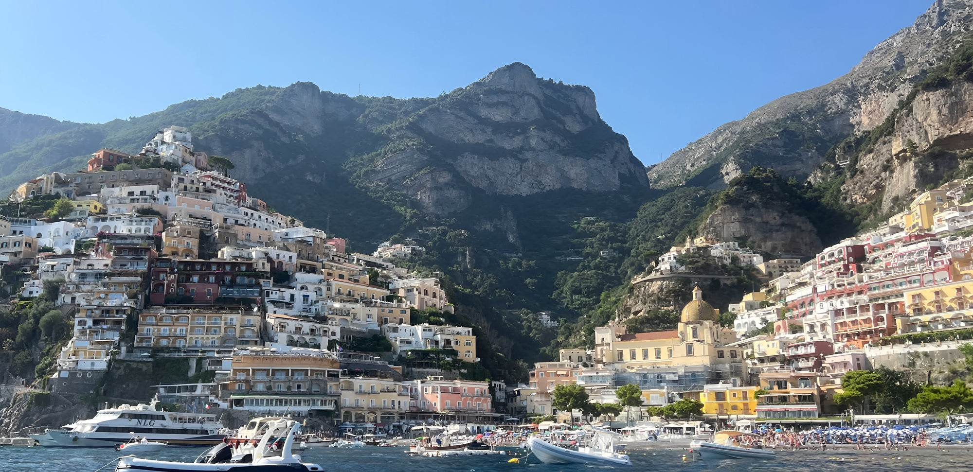 Scenic view of a coastal town with mountains in the background
