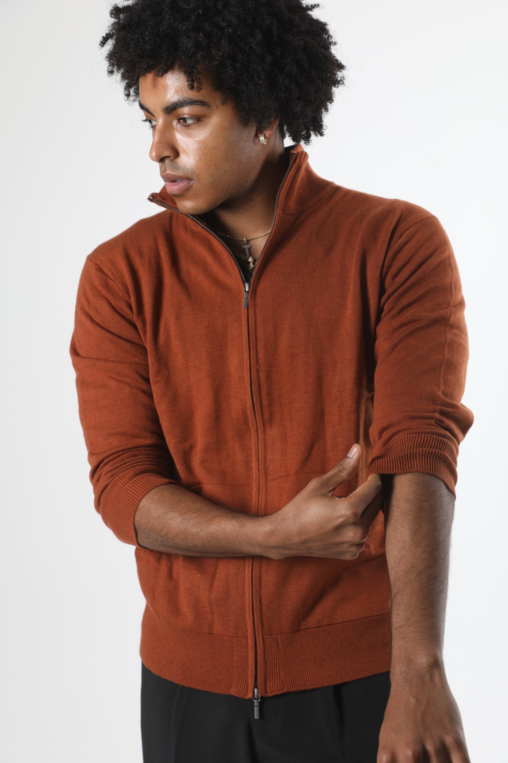 Stedford model wearing a brown zip-up sweatshirt against a white background
